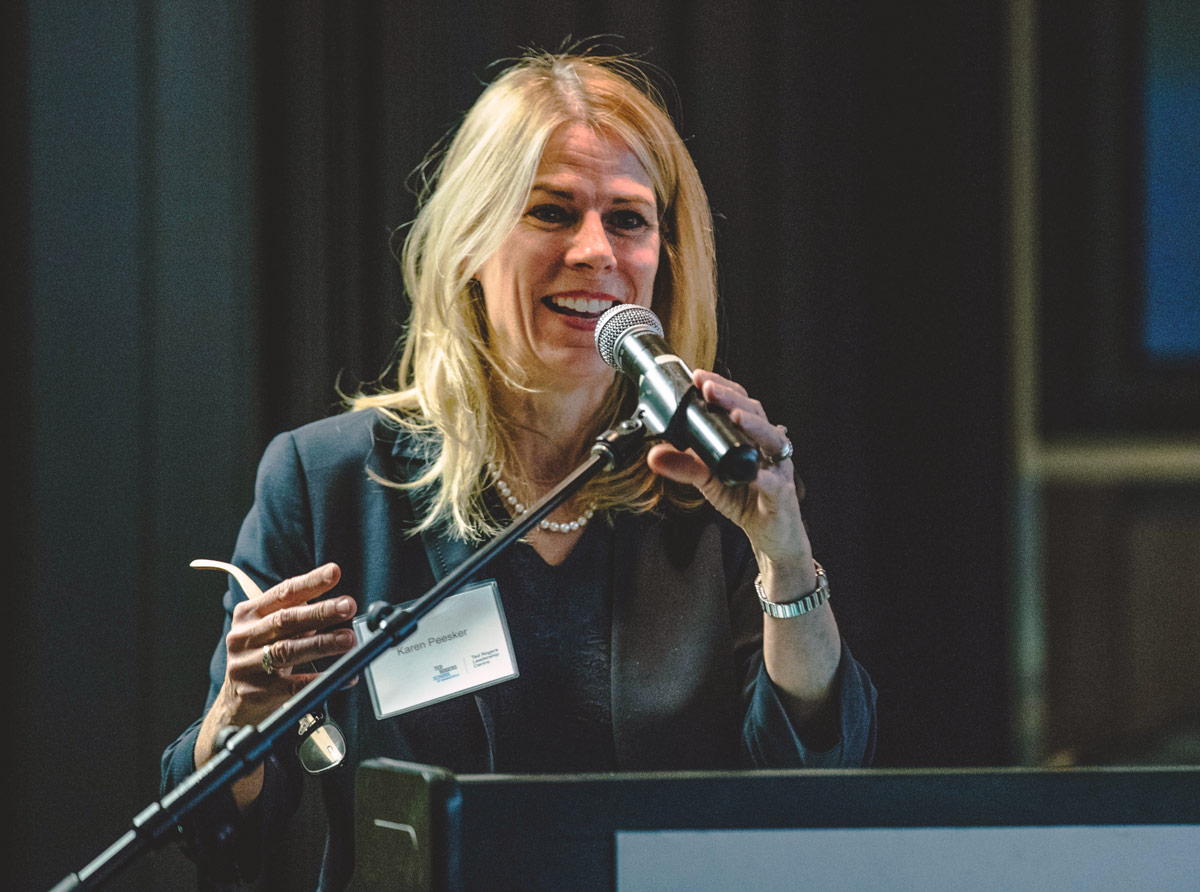 Dr. Karen Peesker speaking into a microphone