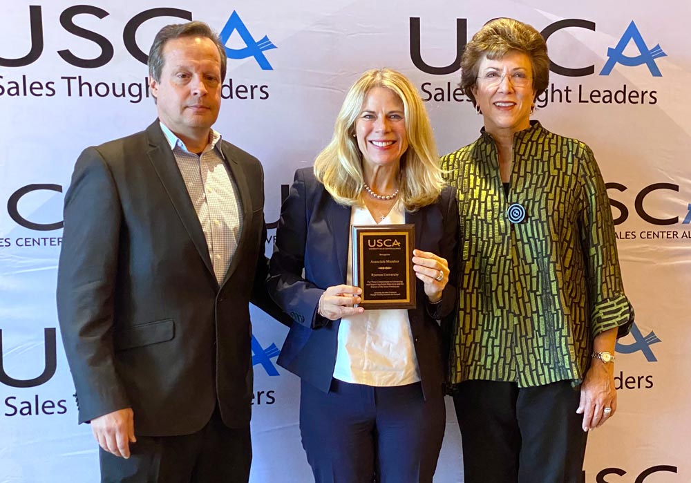 Dr. Karen Peesker holding a USCA Associate Member plaque